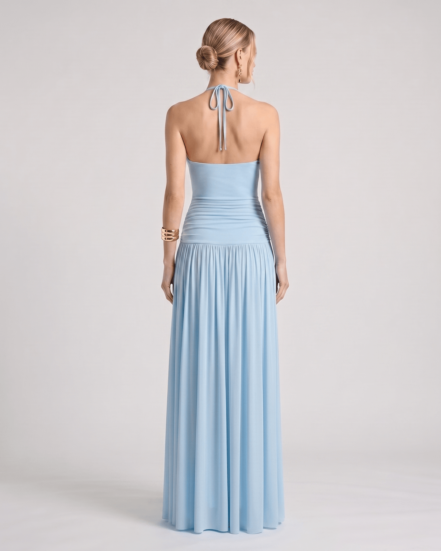 Elara Maxi Dress in soft blue, featuring a halter neck, ruched waist, and fluid maxi-length skirt by Lauven.