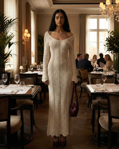 Elara Maxi Dress by Lauven featuring a ribbed V-neck and long flare sleeves, showcased in an elegant dining setting.