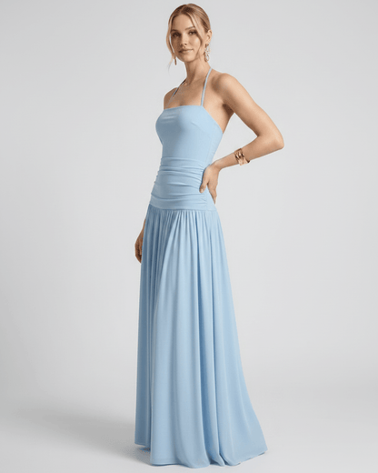 Elara Maxi Dress in light blue, featuring a halter neck, smooth stretch jersey, and fluid full-length skirt by Lauven.