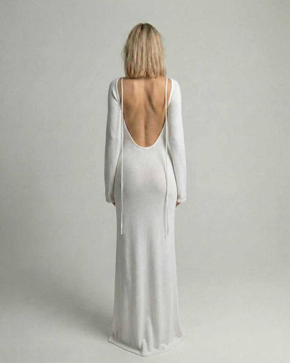 Elara Maxi Dress back view showcasing backless detail, flare sleeves, and elegant white A-line silhouette by Lauven.