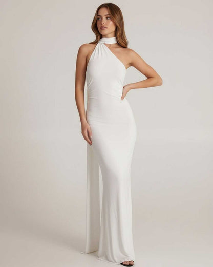 Elara Maxi Dress model wearing a white halter neck dress with open back, showcasing its elegant design by Lauven.
