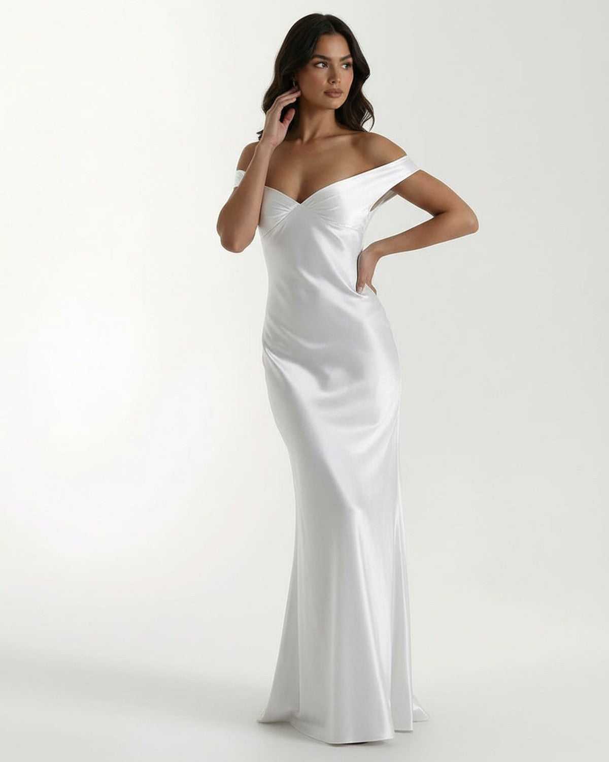 Elara Maxi Dress in white satin with off shoulder design, showcasing elegance and fluid drape from Lauven.