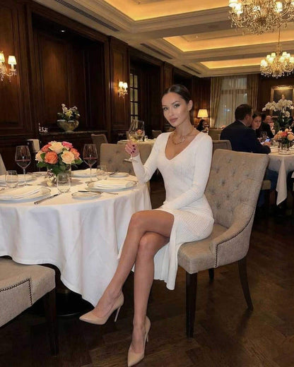 Elara Midi Dress by Lauven, elegant white ribbed knit V-neck pencil dress in a stylish dining setting.