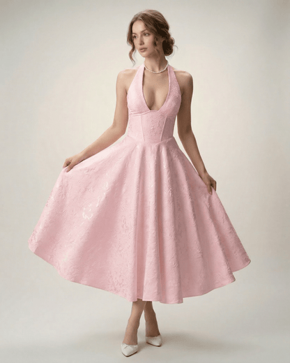 Elara Midi Dress in pink, featuring a halter neckline and A-line silhouette, designed by Lauven for a sophisticated look.