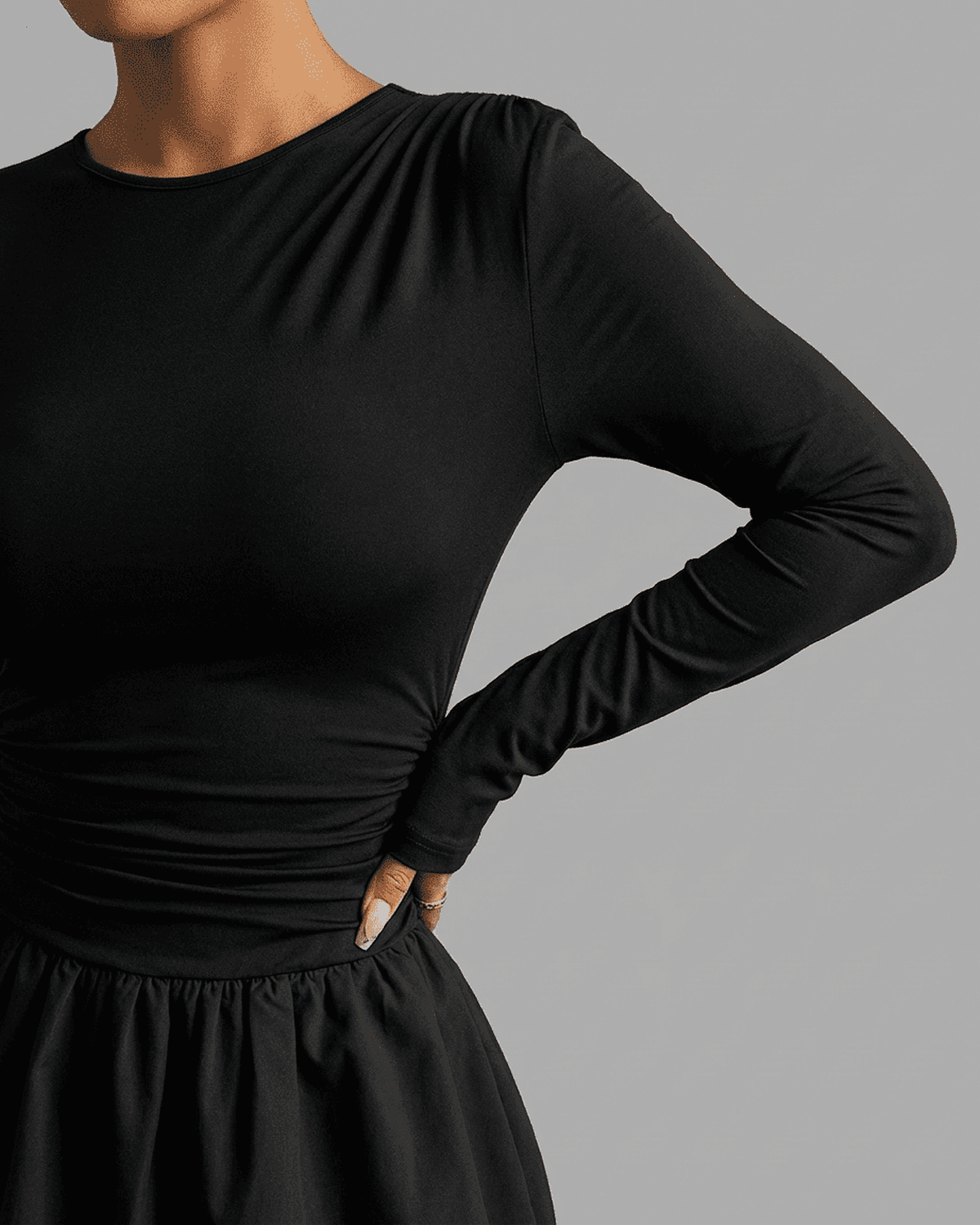 Detail of the Elara Mini Dress by Lauven, featuring fitted long sleeves and a cinched waist design.