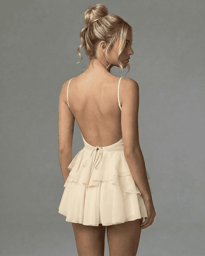 Elara Mini Dress by Lauven - Back view showcasing ruffle skirt and V-neck design.