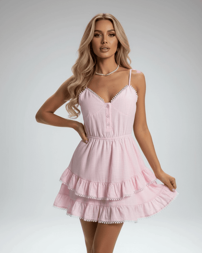 Elara Mini Dress by Lauven, soft pink with tiered ruffle skirt and lace trim, perfect for a feminine summer look.