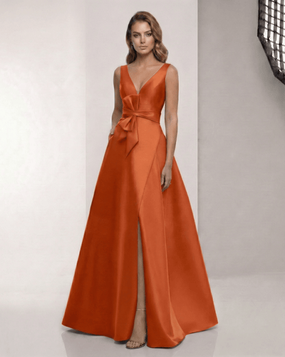 Elaris Maxi Dress - Elegant orange satin dress with A-line silhouette, wrap slit, and bow waist by Lauven.