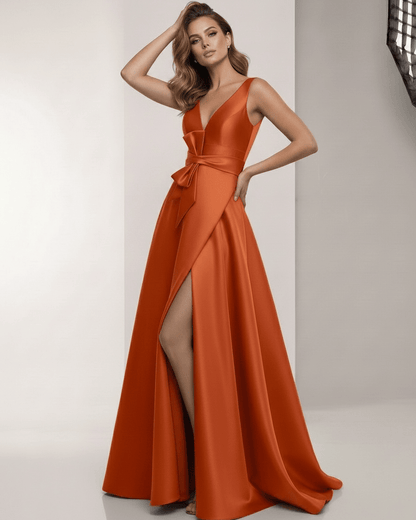 Elaris Maxi Dress in orange satin with A-line silhouette, wrap slit, bow waist from Lauven, elegant and polished look.
