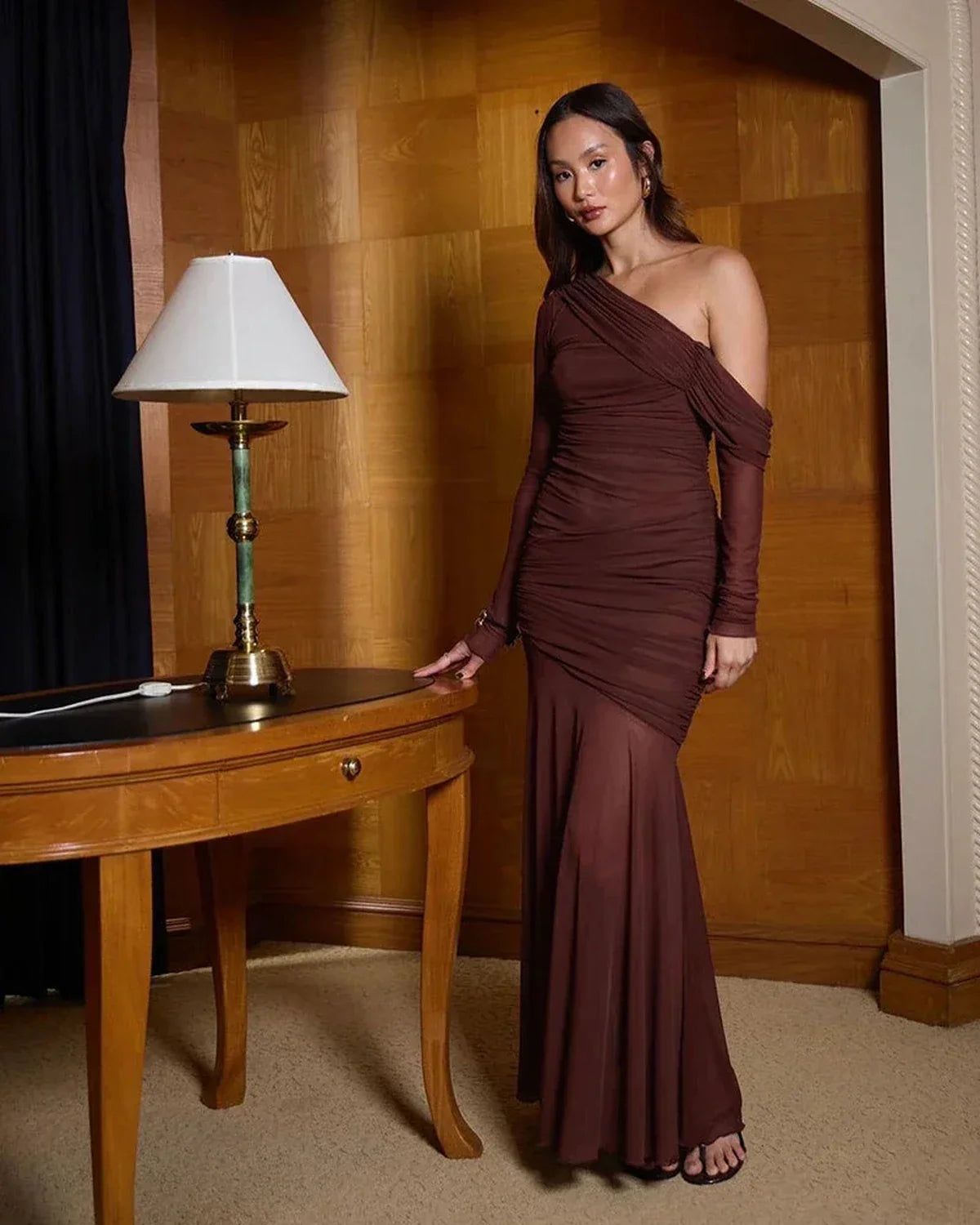 Violet maxi dress with asymmetrical one-shoulder design, soft ruched draping, and flowing skirt, perfect for formal occasions.