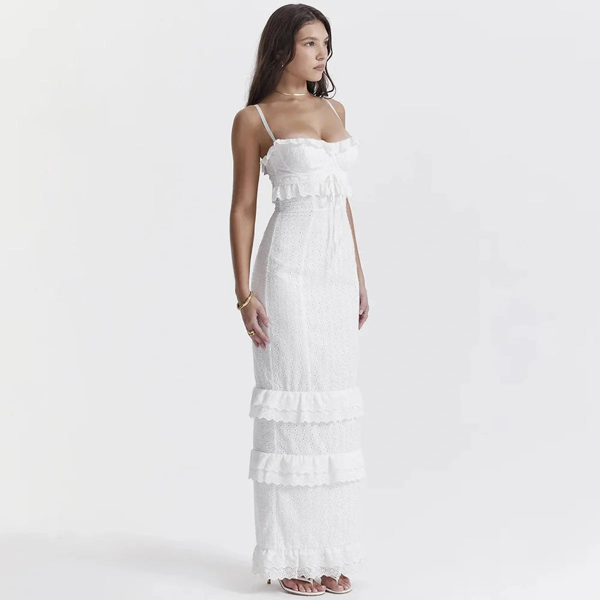 Elegant white maxi dress with ruffles, perfect for wedding guests or summer events, featuring a flowing silhouette.