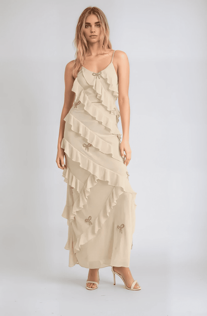 Elodie Dress: Ethereal champagne maxi dress with ruffles and crystal bows, ideal for weddings or formal occasions.