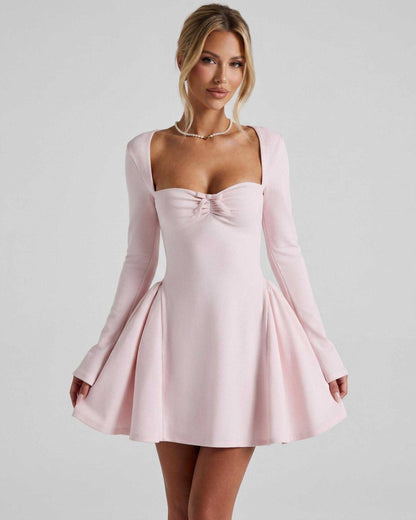 Elvire Mini Dress in light pink, featuring long sleeves, fit-and-flare silhouette, and bow detail by Lauven.