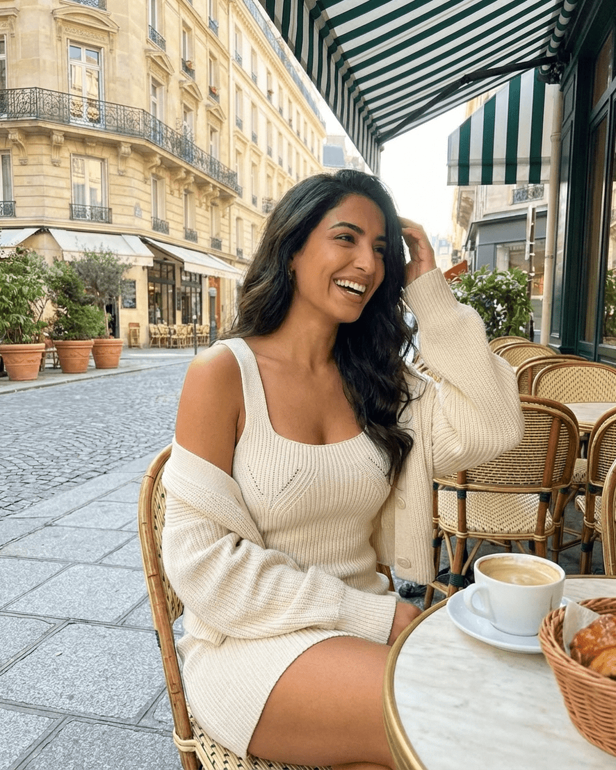 Elysia Mini Dress by Lauven, showcasing a fitted knit design, styled with a cardigan at a chic Parisian café.