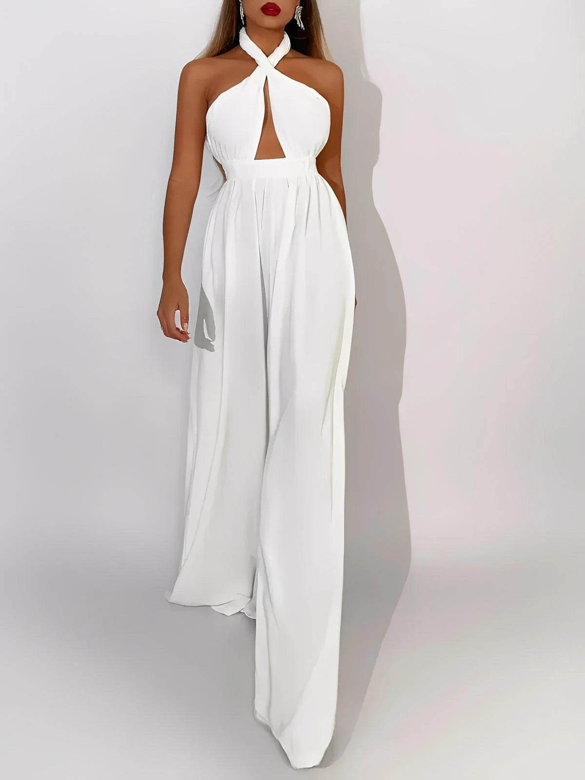 Elysian Jumpsuit in crisp white with halter neck, cut-out bodice, and wide-leg silhouette, ideal for summer soirées.