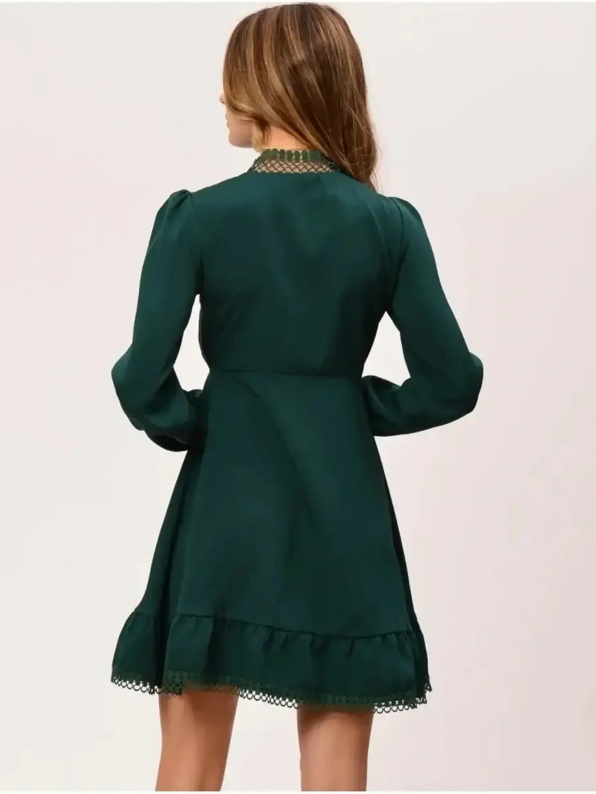 Emerald green mini dress with high stand collar and flared skirt, showcasing a classic feminine silhouette.