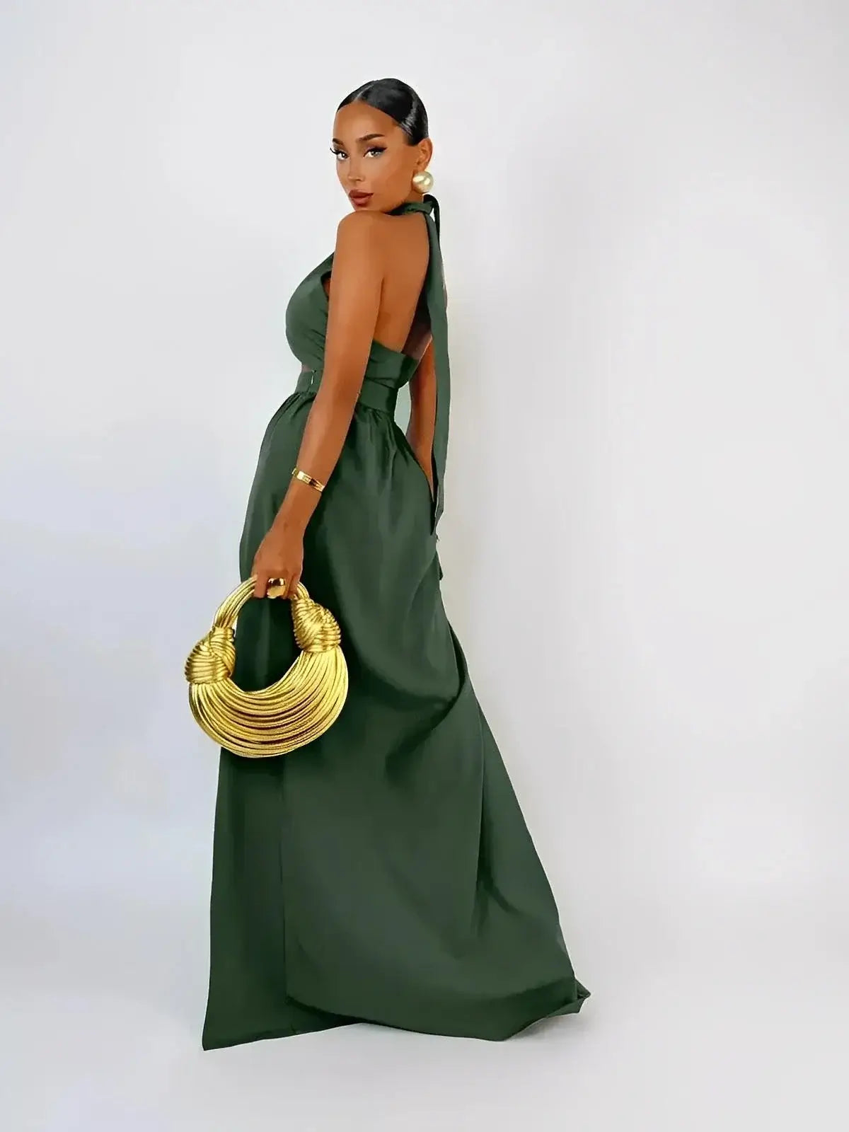 Emerald Muse Set by Lauven featuring a halter crop top and maxi skirt with a dramatic thigh-high slit.