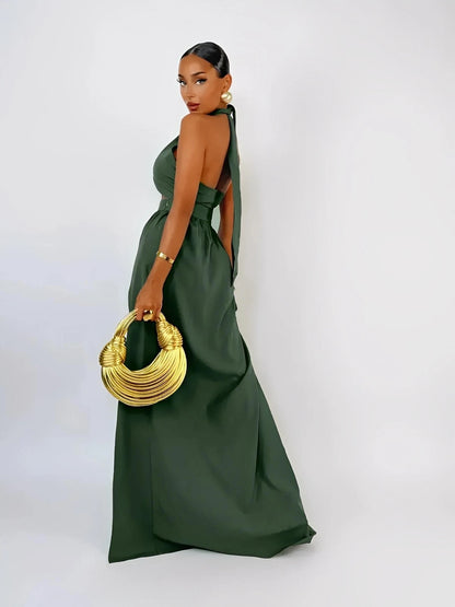 Model showcasing the Emerald Muse Set, a stylish halter crop top and maxi skirt in deep green with a glamorous silhouette.