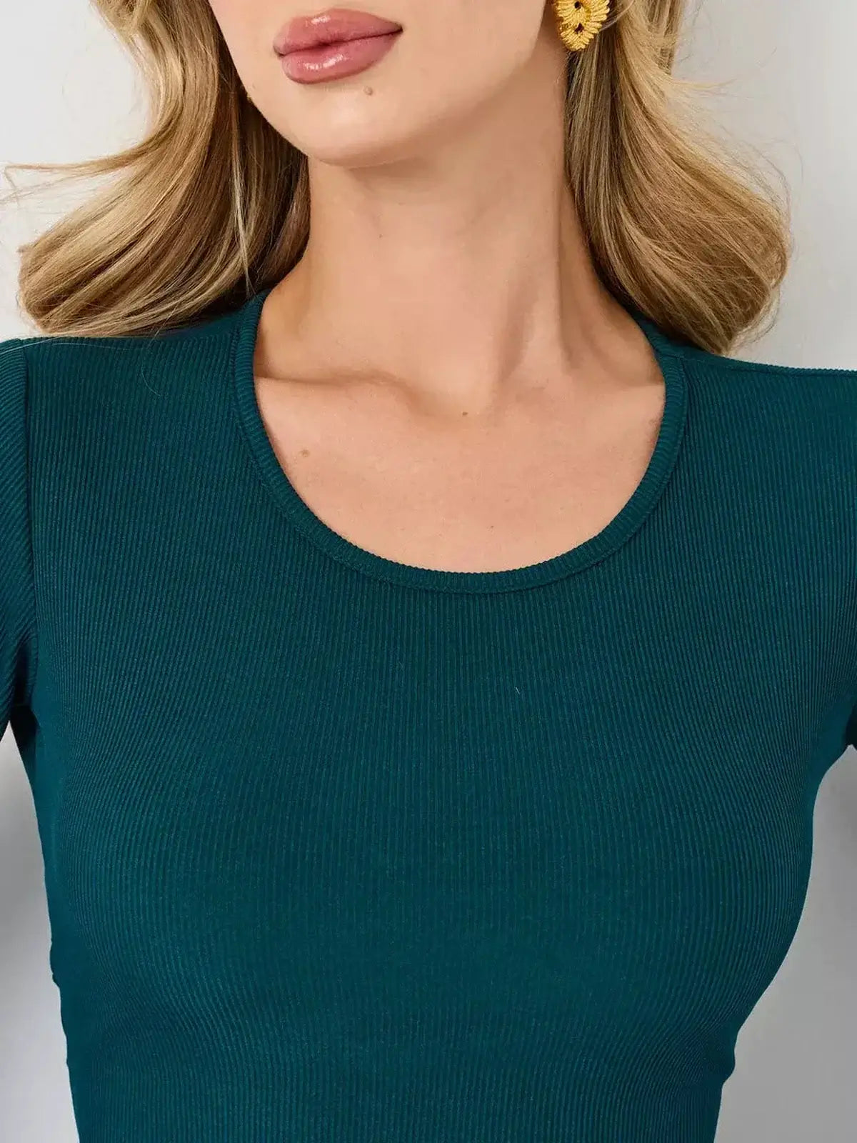 Emerald Whisper mini dress by Lauven, showcasing a rich emerald green hue and flattering A-line silhouette.