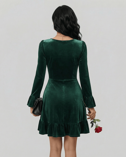 Emeraldia Mini Dress by Lauven, showcasing a back view with long sleeves and a flared hem in luxurious deep green.