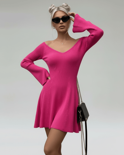 Model wearing Fiora Mini Dress by Lauven, a slim fit pink knit dress with V-neck and flared sleeves.