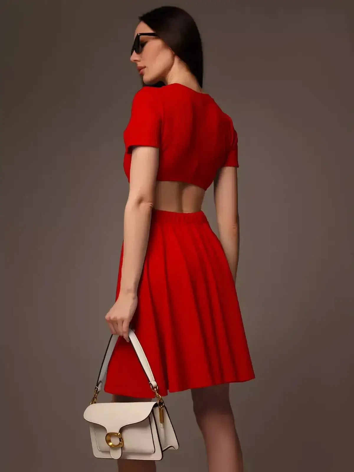 Model showcasing a bold red flare cutout mini dress, perfect for summer events and special occasions.