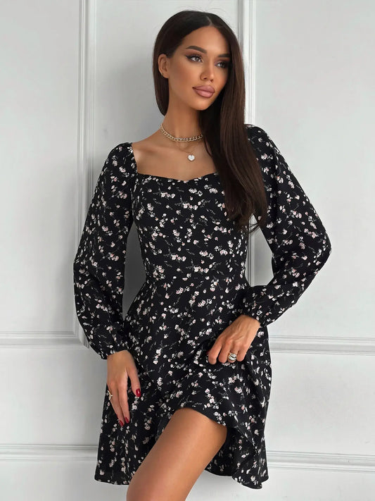 Flora Noir black mini dress with floral print, long sleeves, perfect for wedding guest or cocktail occasions.
