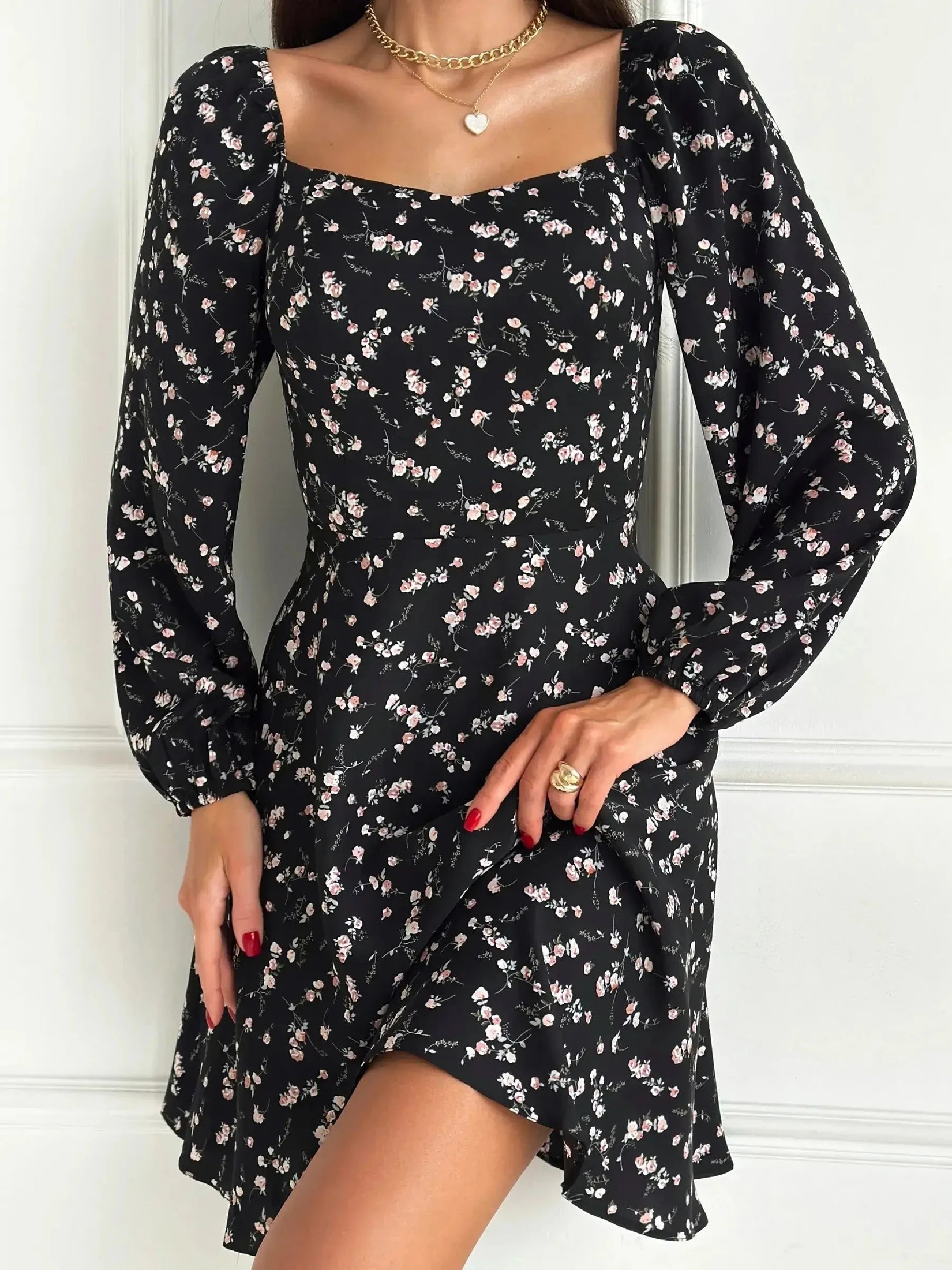 Flora Noir black mini dress with floral print, long sleeves, and flared skirt, perfect for weddings and formal occasions.