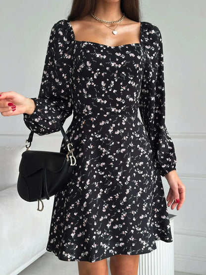 Flora Noir mini dress featuring a floral print, fitted waist, flared skirt, and long sleeves, ideal for summer events.