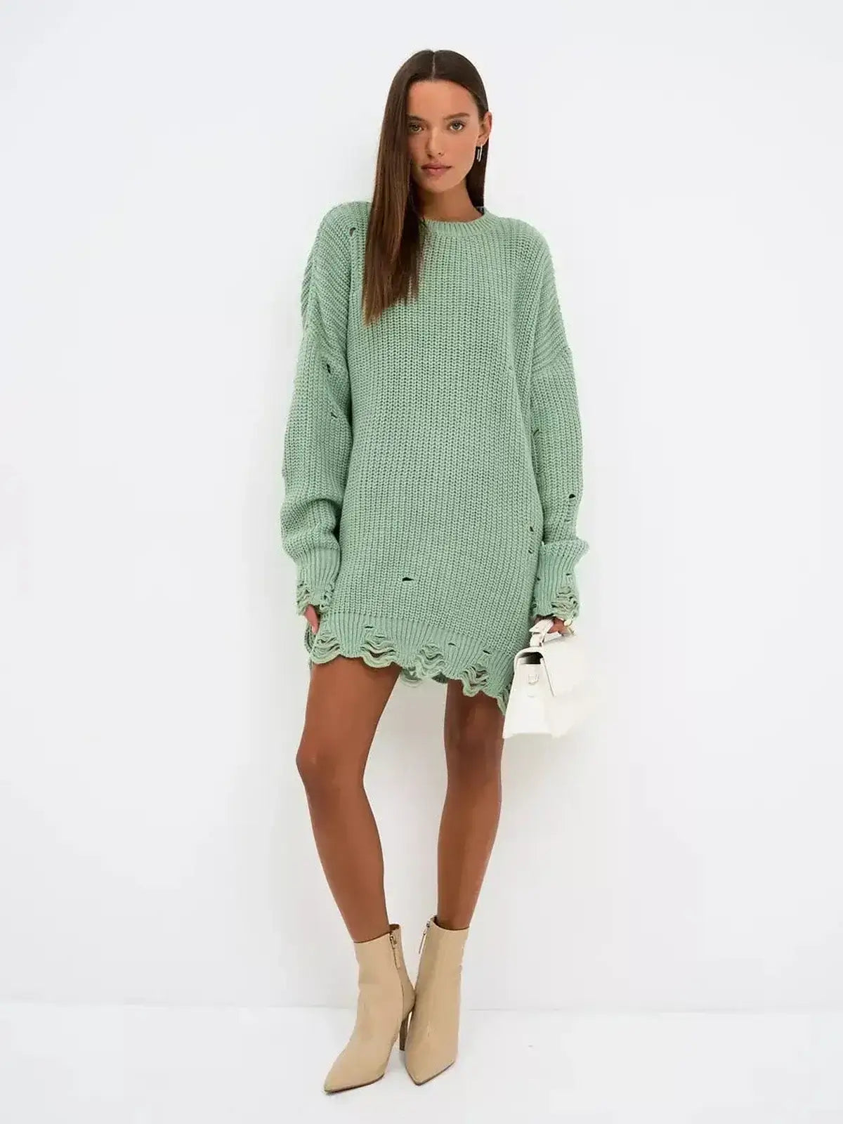 Frost Knit Mini dress in mint green featuring oversized chunky knit and distressed hem, perfect for casual or stylish occasions.