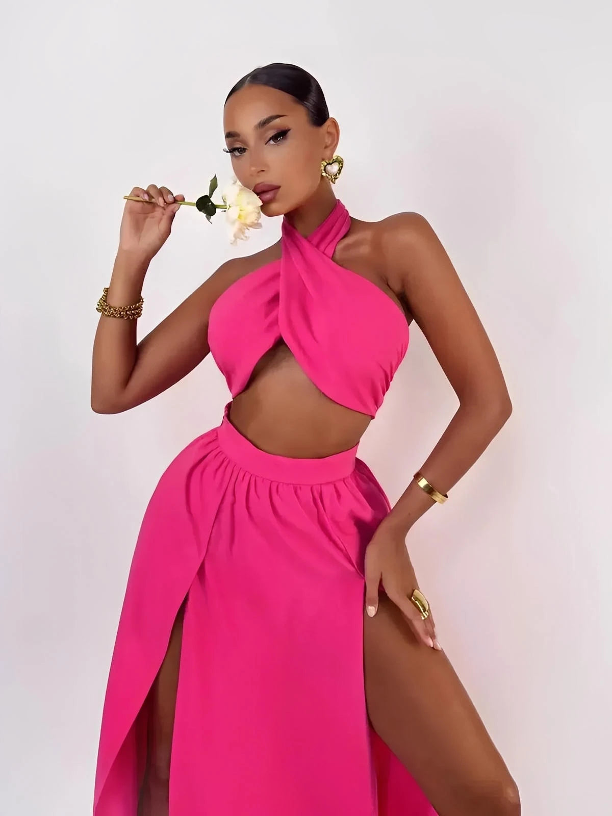 Model showcasing the Fuchsia Breeze Set featuring a criss-cross top and flowing skirt in a bold fuchsia hue.