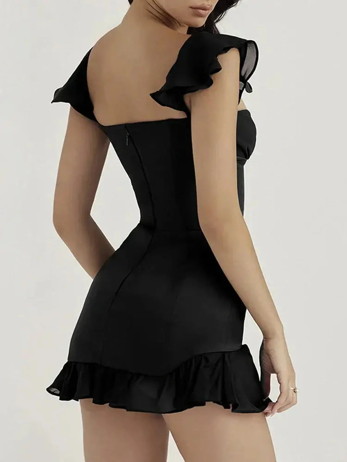 Black mini dress with ruffled sleeves and a flared hem, perfect for parties and evening events.
