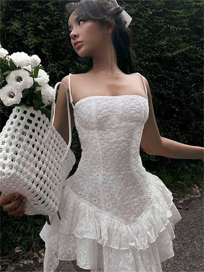 Grace Mini Dress in white, featuring lace detail and ruffled hem, perfect for wedding guests or summer occasions.