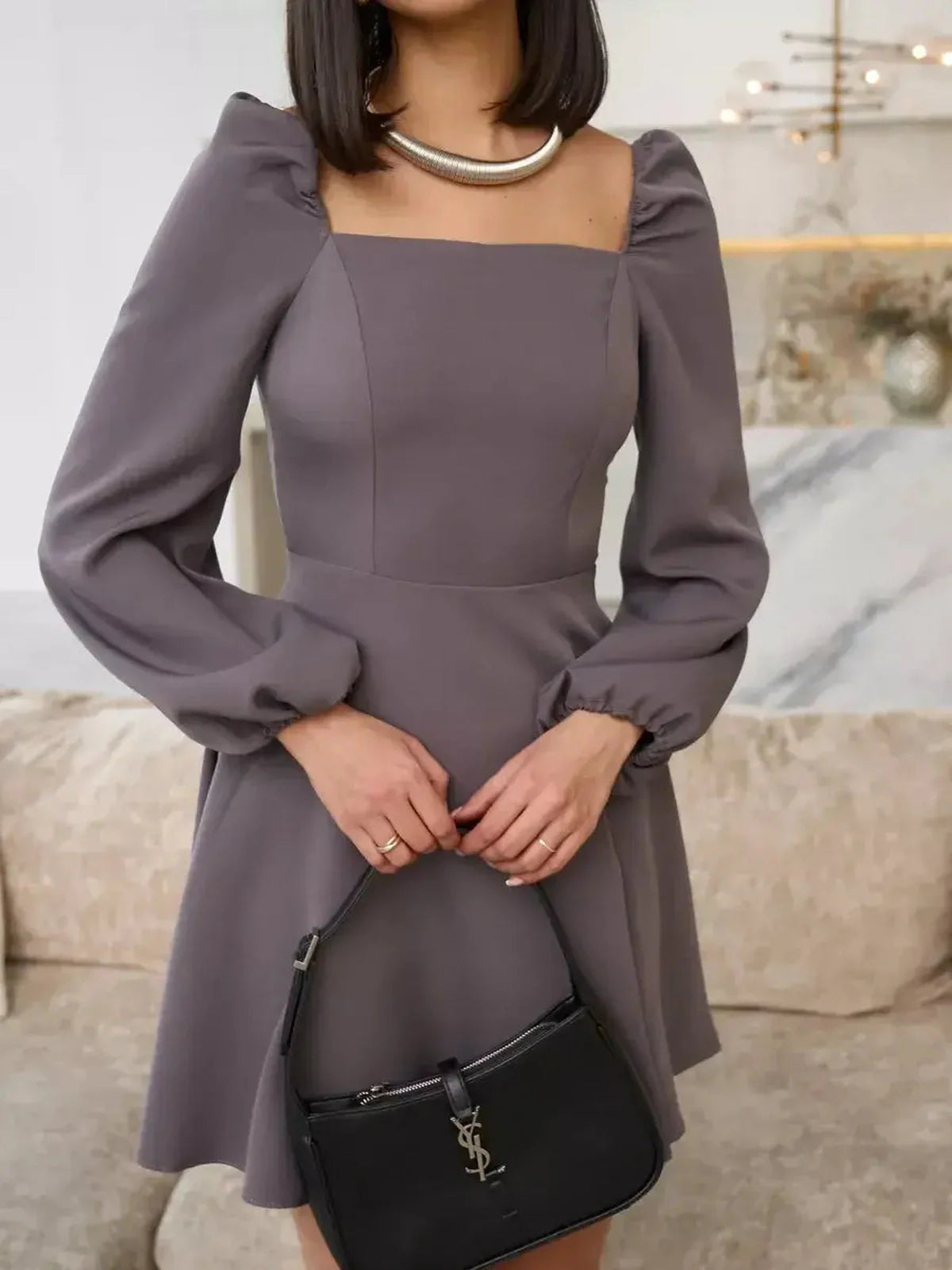 Graphite Bloom mini dress with puffed sleeves, square neckline, and black handbag, perfect for weddings and formal events.