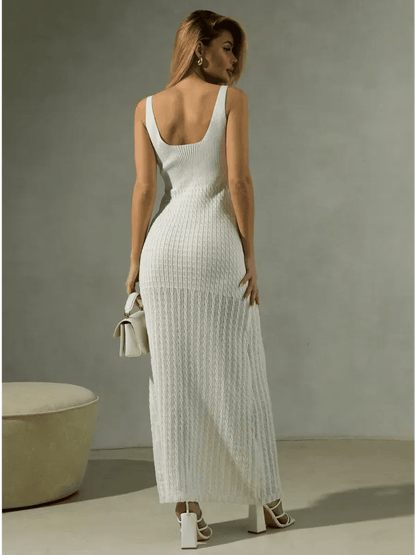 Woman wearing a white knit maxi dress showcasing a sculpted silhouette and open back design.