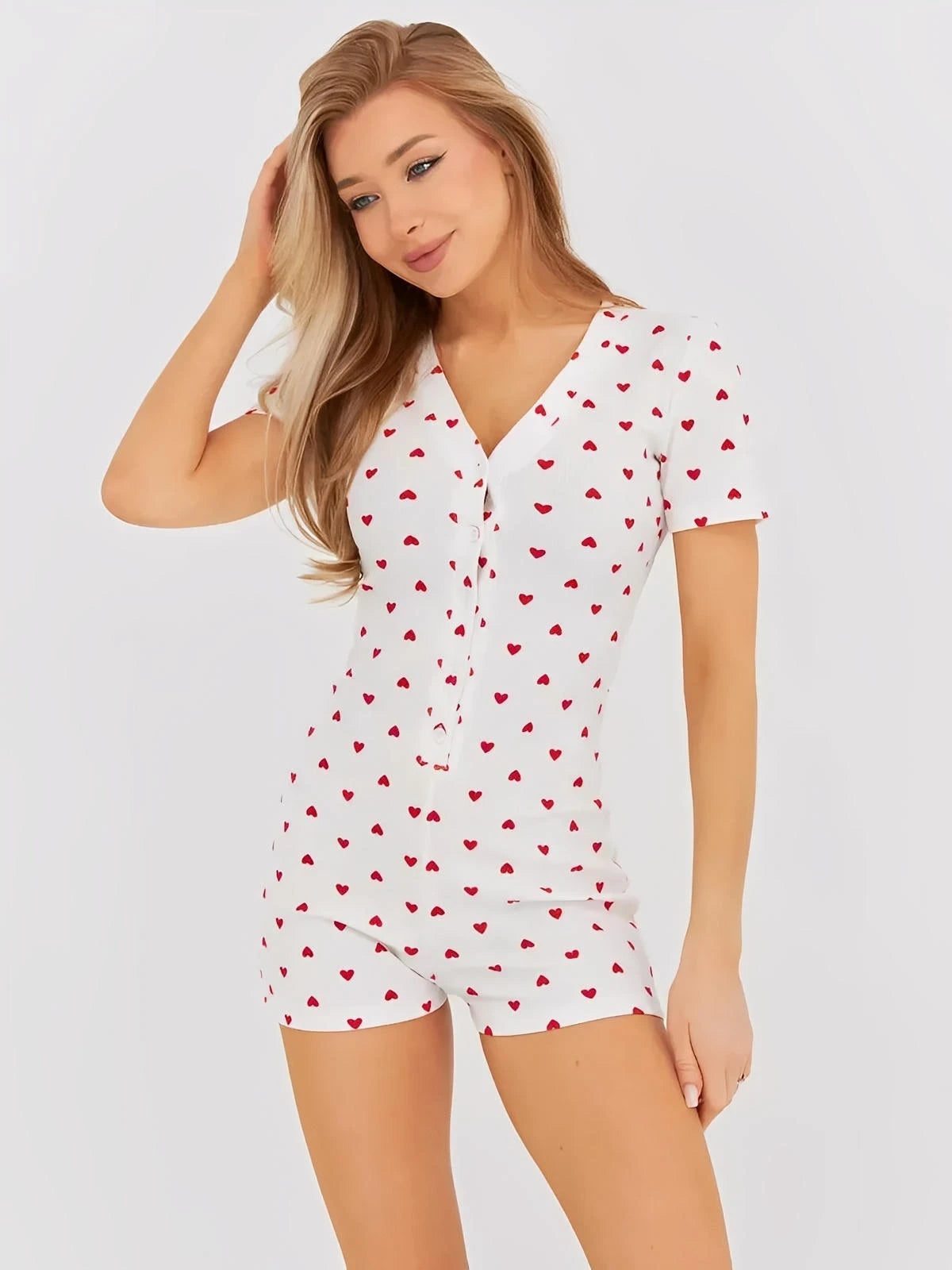 Heartprint V-Neck Romper for Women in white with red heart pattern, featuring a button front and relaxed fit.