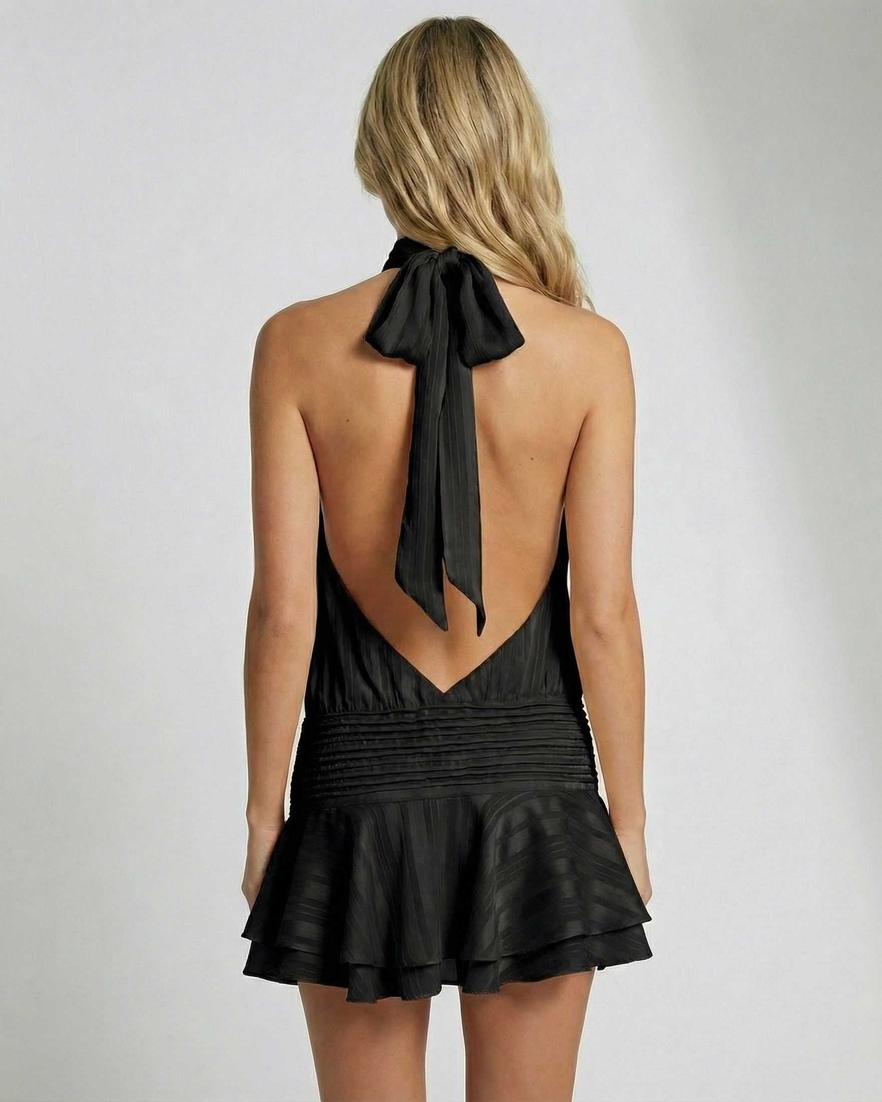 Noiré Mini Dress by Lauven, pleated chiffon halter mini dress in black with an open back and bow detailing.