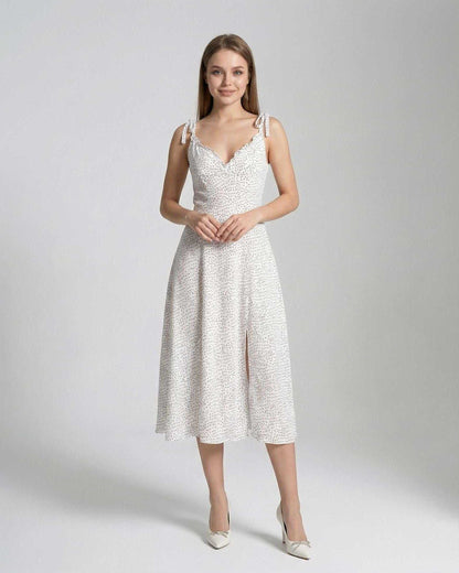 Elara Midi Dress by Lauven, featuring a sleeveless A-line silhouette with polka dot detail, perfect for elegant occasions.