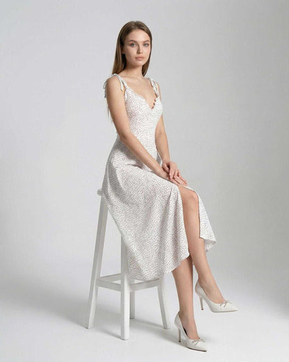 Elara Midi Dress by Lauven, featuring an elegant A-line silhouette and polka dot detail, showcasing graceful movement.
