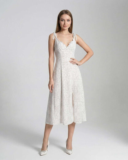 Elara Midi Dress by Lauven showcasing elegant A-line silhouette with polka dot detail and feminine design.