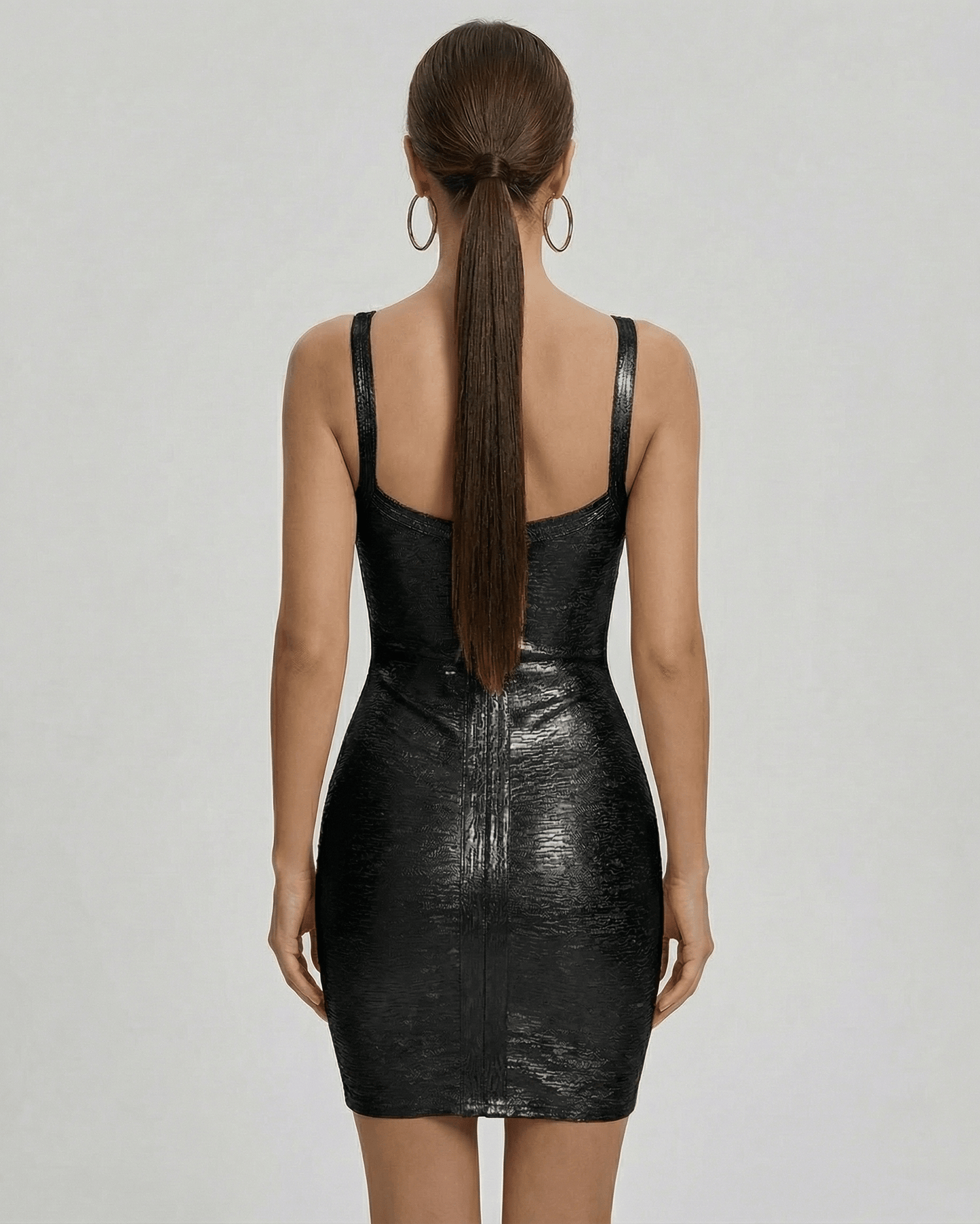 Back view of the Lyra Mini Dress by Lauven, showcasing its sleek black bodycon design and fitted silhouette.