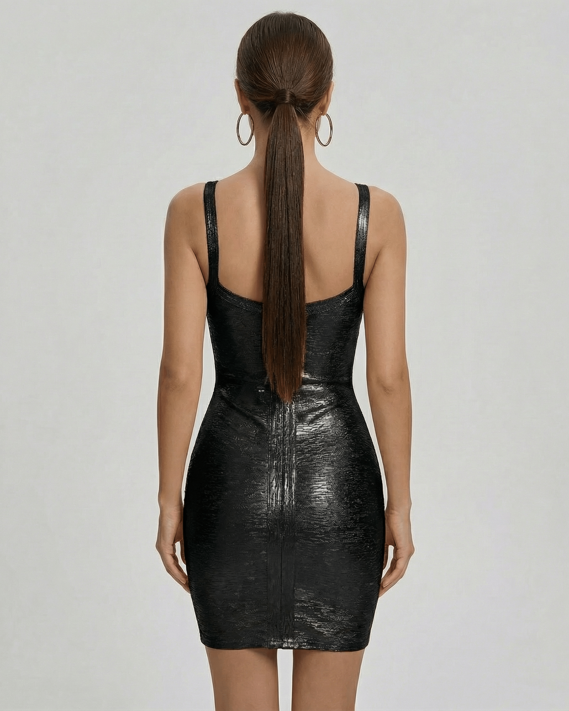 Back view of the Lyra Mini Dress by Lauven, showcasing its sleek black bodycon design and fitted silhouette.