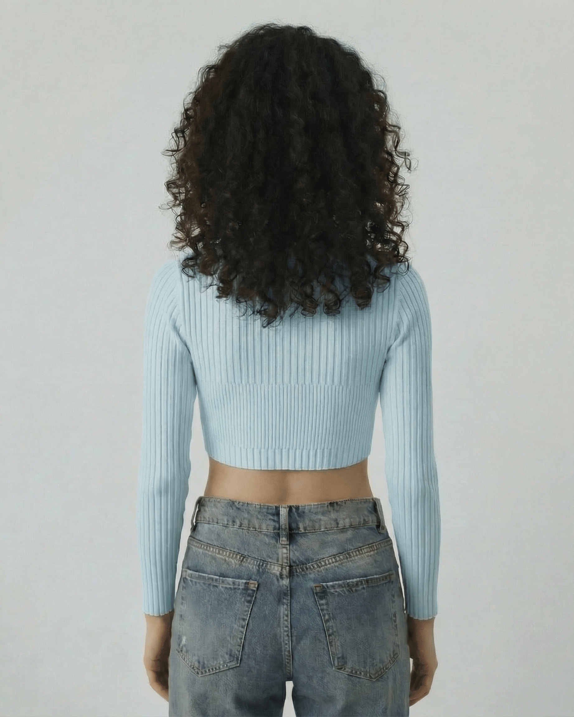 Celeste Top by Lauven, women's light blue ribbed knit long sleeve top, back view, showing modern cut-out style.