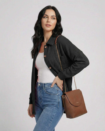 Milano Jacket by Lauven - Women’s black waffle knit jacket with longline fit, paired with a stylish handbag.