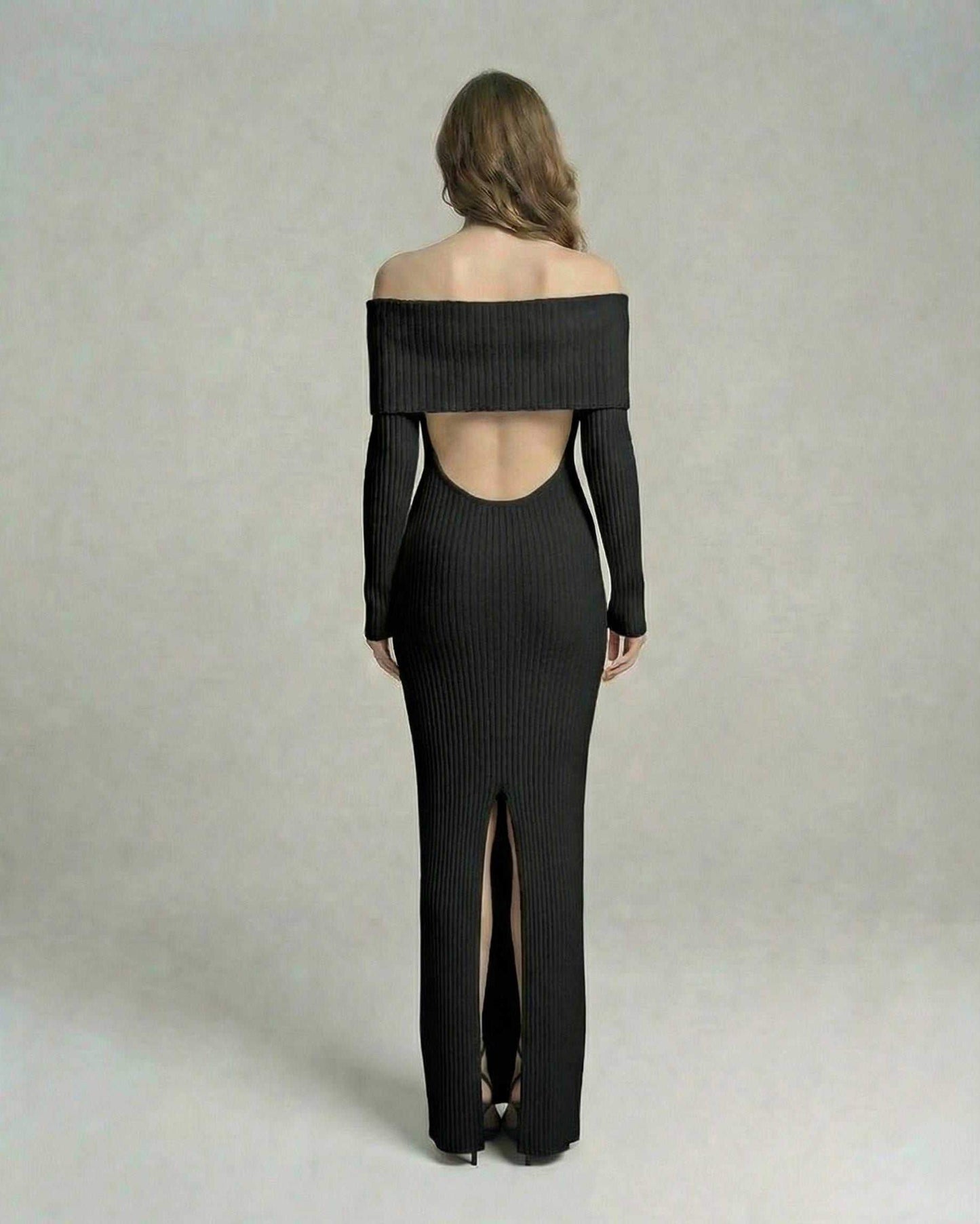 Back view of Lauven Noir Maxi Dress with off-shoulder neckline and thigh-high slit in ribbed black fabric.