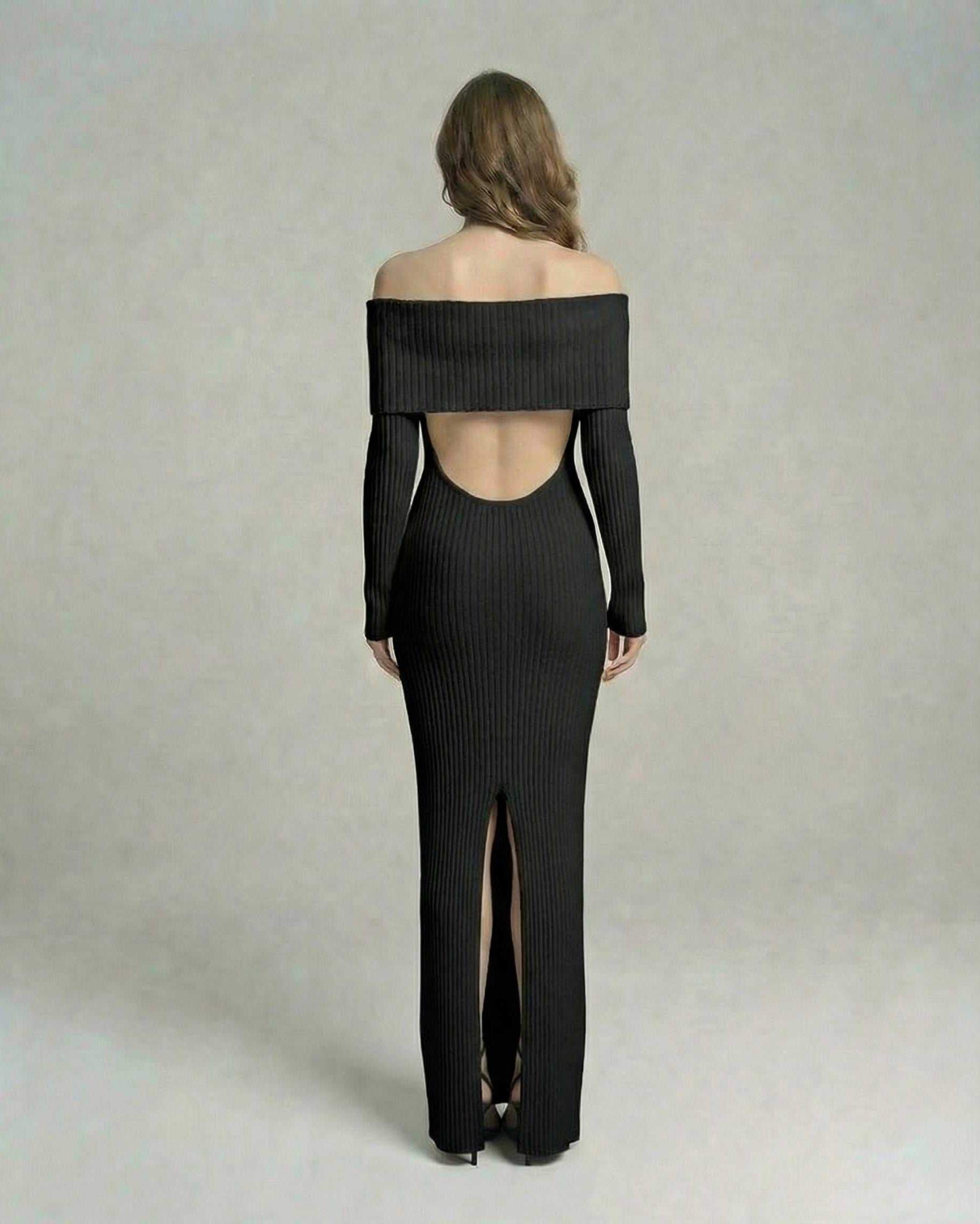 Back view of Lauven Noir Maxi Dress with off-shoulder neckline and thigh-high slit in ribbed black fabric.