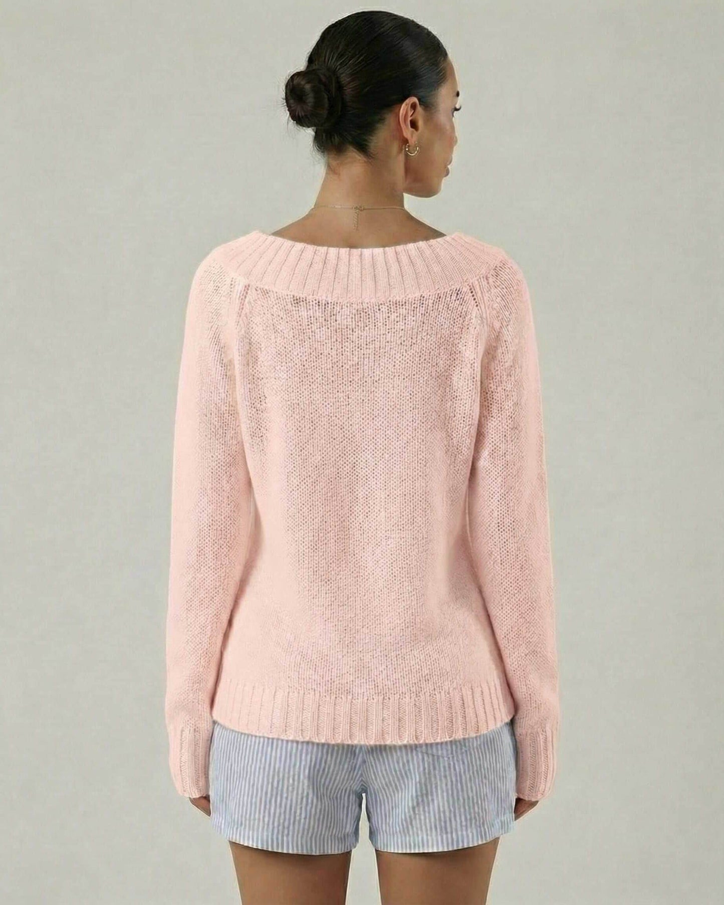 Back view of the Rosaline Sweater by Lauven, a women's pink boat neck sweater with rib knit detail.