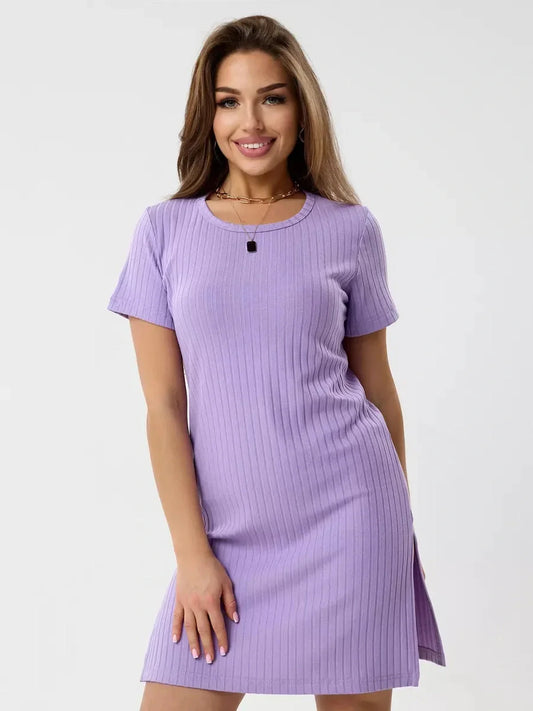 Confident model wearing a light violet ribbed mini dress with short sleeves and side slits, showcasing a flattering fit.