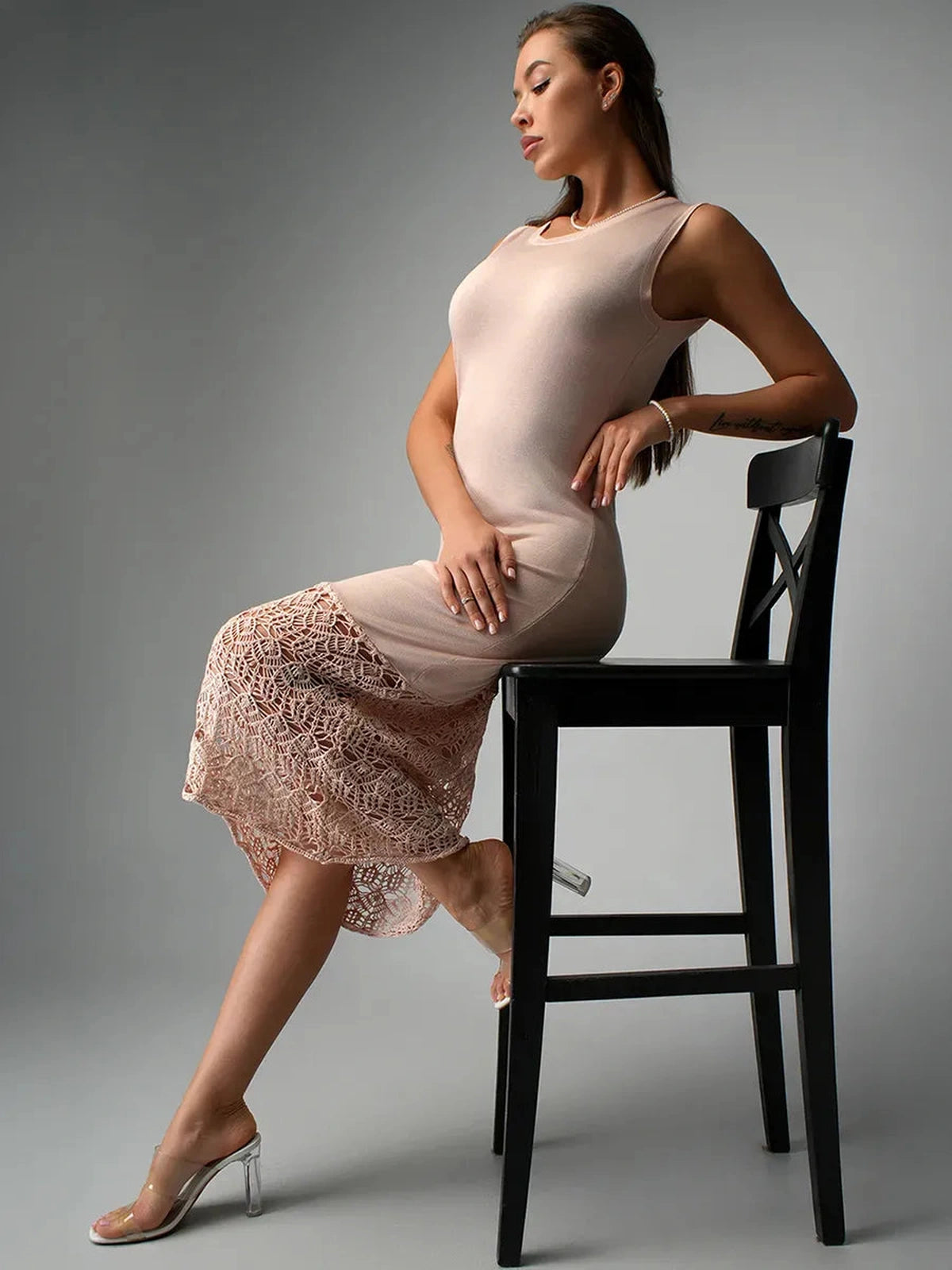 Elara Midi Dress by Lauven, showcasing a sleek beige knit silhouette with crochet lace hem on a model.