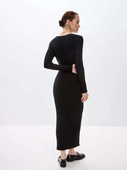 Back view of a woman wearing a Sculpted Rib Maxi Dress in black, highlighting the streamlined silhouette and ribbed texture.